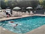 View larger image of A boy enjoying the swimming pool at SMOKY BEAR CAMPGROUND AND RV PARK image #3