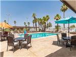 Covered tables by the pool - thumbnail