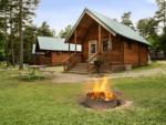 Cabin with fire pit in front at Jellystone Park (TM) of Western New York - thumbnail