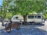 View larger image of A travel trailer next to a tree at OUTBACK RV RESORT image #10
