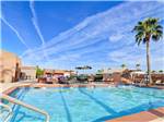 View larger image of Swimming pool with outdoor seating at APACHE WELLS RV RESORT image #1