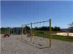 A swing set next to a playground at BORDEN/SUMMERSIDE KOA - thumbnail
