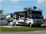 View larger image of A motorhome parked in a paved RV site at HAWAIIAN ISLES image #4