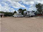 A couple of RVs in a RV site at STAMPEDE RV PARK - thumbnail