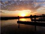 The empty docks at sunset at SUGAR BARGE RV RESORT AND MARINA - thumbnail