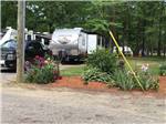 A flower planter next to an RV site at CAMPTOWN CAMPGROUND - thumbnail