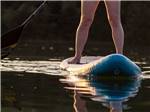 A person on a standing paddle board at HTR TX HILL COUNTRY - thumbnail