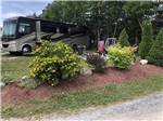View larger image of A planter area next to an RV site at GROS MORNENORRIS POINT KOA image #1