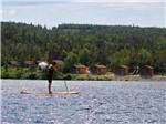 View larger image of A person on a stand up paddle board at GROS MORNENORRIS POINT KOA image #2