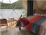 View larger image of Inside of a glamping geodesic dome overlooking the water at GROS MORNENORRIS POINT KOA image #3