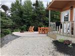 View larger image of A seating area next to a rental cabin at GROS MORNENORRIS POINT KOA image #7