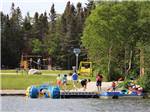 View larger image of A group of people getting ready to get in a pedal boat at GROS MORNENORRIS POINT KOA image #8
