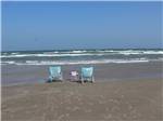Three folding chairs on the sand at the beach at PIONEER BEACH RESORT - thumbnail