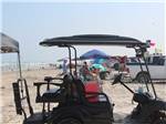 A golf cart and people at the beach at PIONEER BEACH RESORT - thumbnail