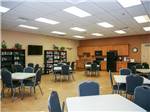 Tables and chairs in the recreation hall at COTTON LANE RV RESORT - thumbnail