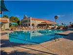 View larger image of Beautiful pool outside spectacular main building at SUNRISE RV RESORT image #1