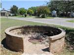The closed fire pit with a brick wall at QUAIL SPRINGS RV PARK - thumbnail