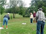 A group of people playing a lawn game at COZY C RV CAMPGROUND - thumbnail