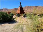 View larger image of A metal teepee in the sand at STAGECOACH TRAILS RV PARK image #2