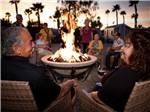View larger image of Guests enjoying the evening in front of a fire pit at GOLD CANYON RV  GOLF RESORT image #4
