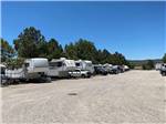 Gravel road with RVs parked in distance at BAR S RV PARK - thumbnail