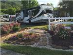 A well manicured RV site at KING'S HOLLY HAVEN RV PARK - thumbnail