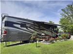 A motorhome with an open awning at KING'S HOLLY HAVEN RV PARK - thumbnail