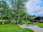 A motorhome parked by a site by the lake at SPRING LAKE RV RESORT - thumbnail