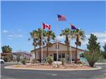 View larger image of Three flag poles in front of the main building at CT RV RESORT image #7
