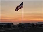 View larger image of The American flag at dusk at CT RV RESORT image #12