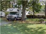 View larger image of RV with slide outs in a tree shaded site at TOWN MOUNTAIN TRAVEL PARK image #2