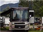 A motorhome parked in a gravel site at COLUMBIA FALLS RV PARK - thumbnail