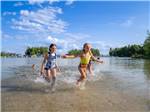 Girls running in the water - thumbnail