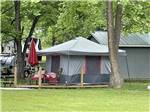 A large tent between trees at SMOKY MOUNTAIN MEADOWS CAMPGROUND - thumbnail