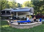 People sitting in a patio area at an RV site at AUSTIN LAKE RV PARK & CABINS - thumbnail