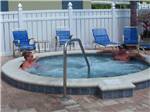 View larger image of Couple in hot tub at YANKEE TRAVELER RV PARK image #3