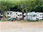 View larger image of A couple of RVs in gravel sites at COLORADO LANDING RV PARK image #2