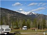 A pop-up tent and van camper parked with snow capped mountain behind at IRVIN'S PARK & CAMPGROUND - thumbnail