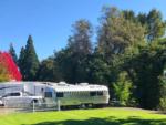 Trailers and white picket fence at RISING RIVER RV RESORT & RIVER HOUSE - thumbnail