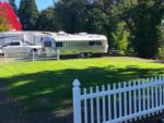 Grassy area between two picket fences at RISING RIVER RV RESORT & RIVER HOUSE - thumbnail