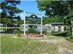 View larger image of The front entrance sign at WOODLAND LAKES RV PARK image #1