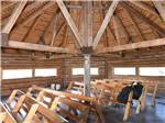 Wooden seating inside the barn at COUNTRY ROADS RV PARK - thumbnail