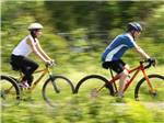 A couple riding mountain bikes at SUGAR RIDGE RV VILLAGE & CAMPGROUND - thumbnail