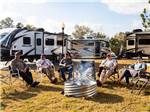 Campers gathered around a firepit - thumbnail