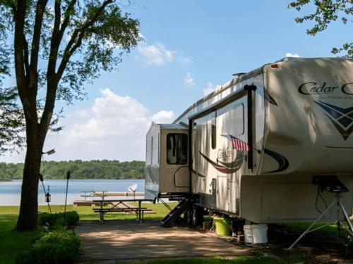 An RV parked in a site by the lake