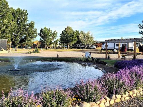 Flowers around a water feature at MEADOWS OF SAN JUAN RV RESORT