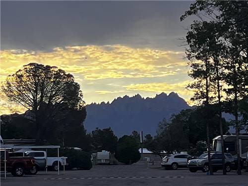 The sun sets over the mountains at Sunny Acres RV Park