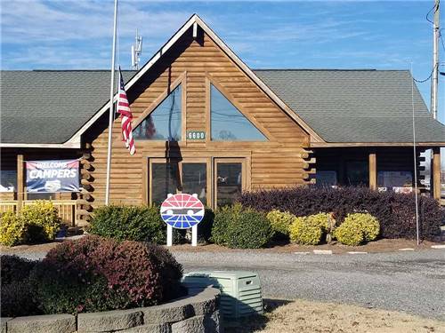 Wooden main cabin of campground with American flag at half mast at CAMPING WORLD RACING RESORT