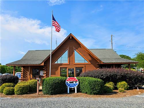 Wooden main cabin of campground with American flag at half mast at CAMPING WORLD RACING RESORT