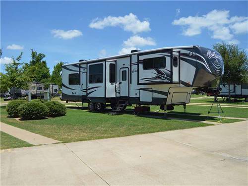 A fifth wheel trailer in RV site at BUSHMAN'S RV PARK